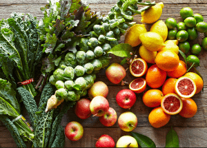a group of fruits and vegetables on a wood surface Healthy Weight Loss Diets Market Drayton