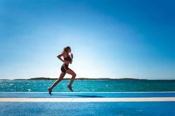 Woman running showing strong leg muscle Market Drayton